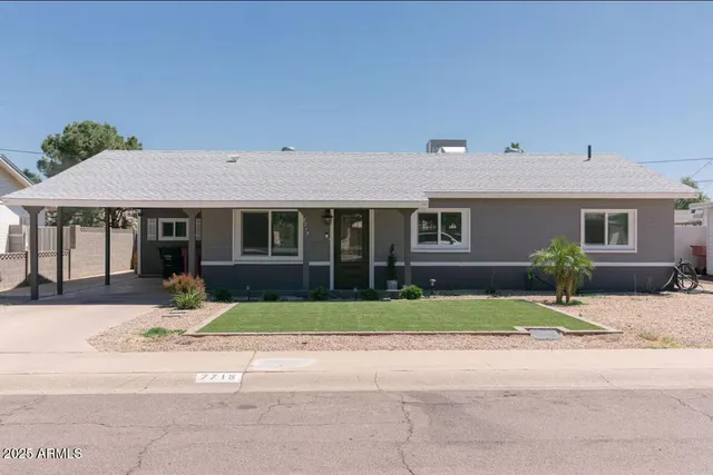 a front view of a house with a yard and a garage