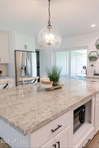 a view of a kitchen counter top space and living room