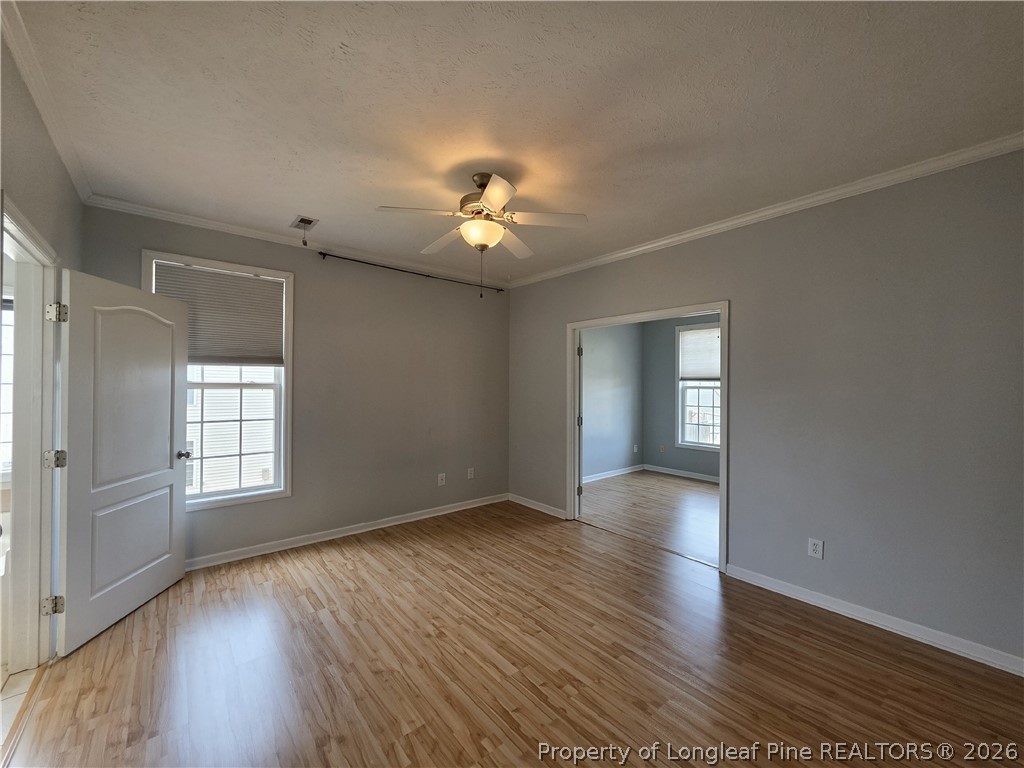 1324 Kershaw Loop, Unit 206 Fayetteville, NC 28314 - Photo 11 of 26 an empty room with wooden floor and windows