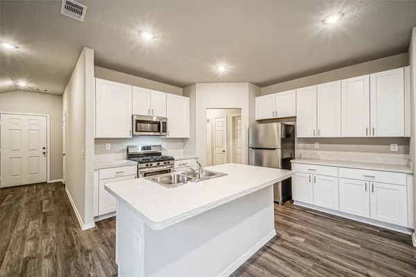 a kitchen with refrigerator cabinets and a counter top space