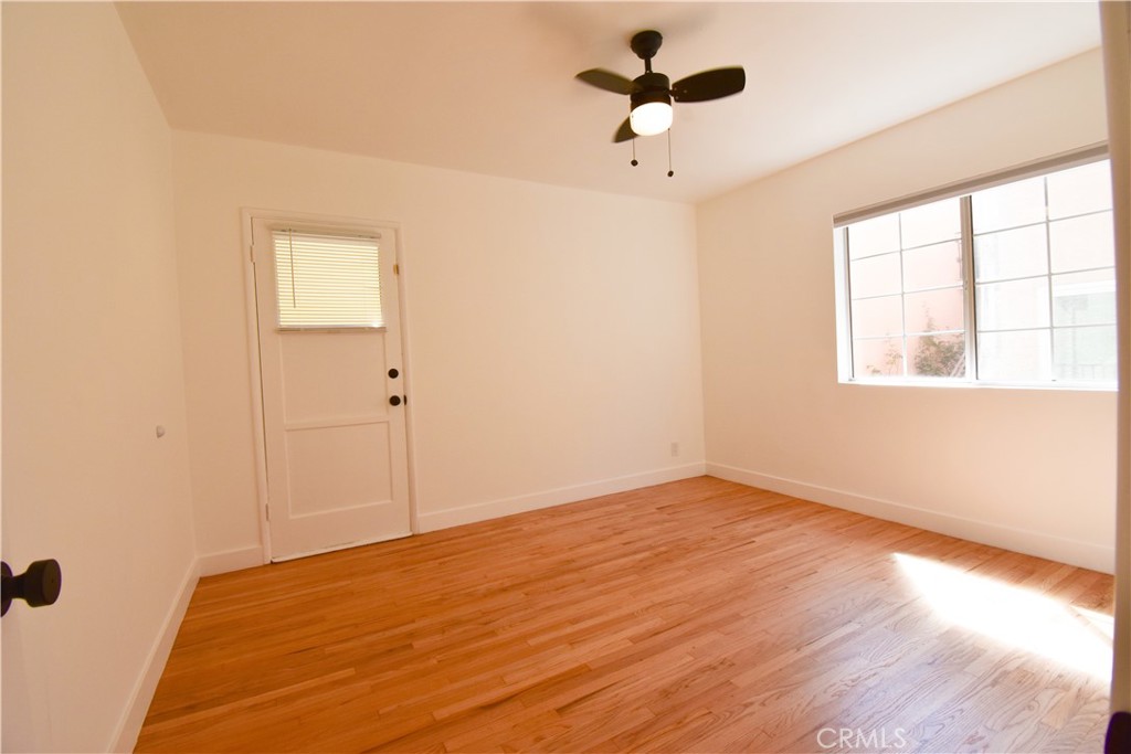 1570 North Verdugo Road, Unit B Glendale, CA 91208 - Photo 10 of 12 an empty room with wooden floor chandelier fan and windows