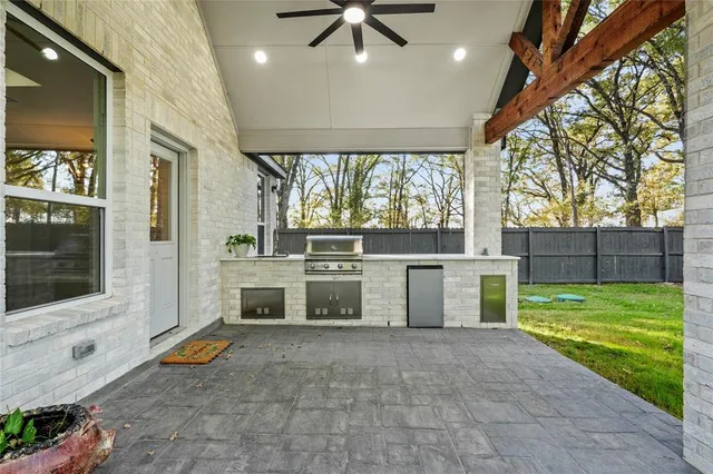 a bathroom with a double vanity sink mirror and bathtub