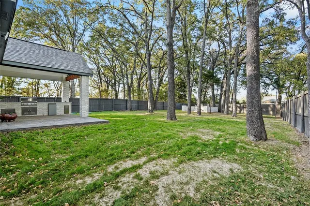 a view of a house with a backyard and a patio