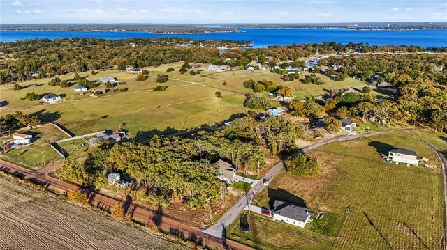 a front view of a house with yard and green space