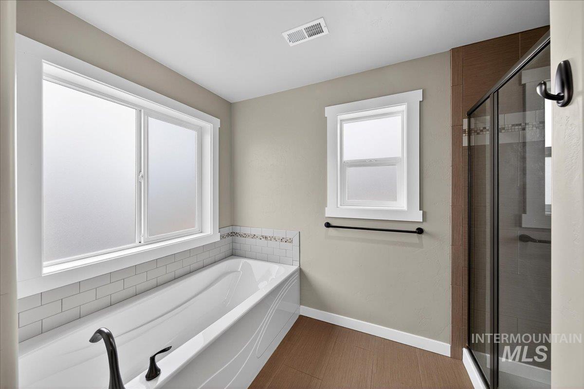 12200 West Oneida Street Boise, ID 83709 - Photo 10 of 35 Bathroom with a bath and a shower stall