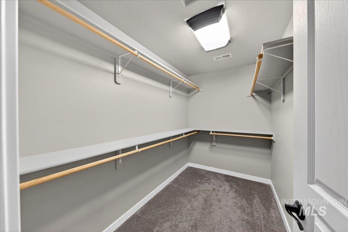 12200 West Oneida Street Boise, ID 83709 - Photo 12 of 35 Walk in closet featuring dark colored carpet