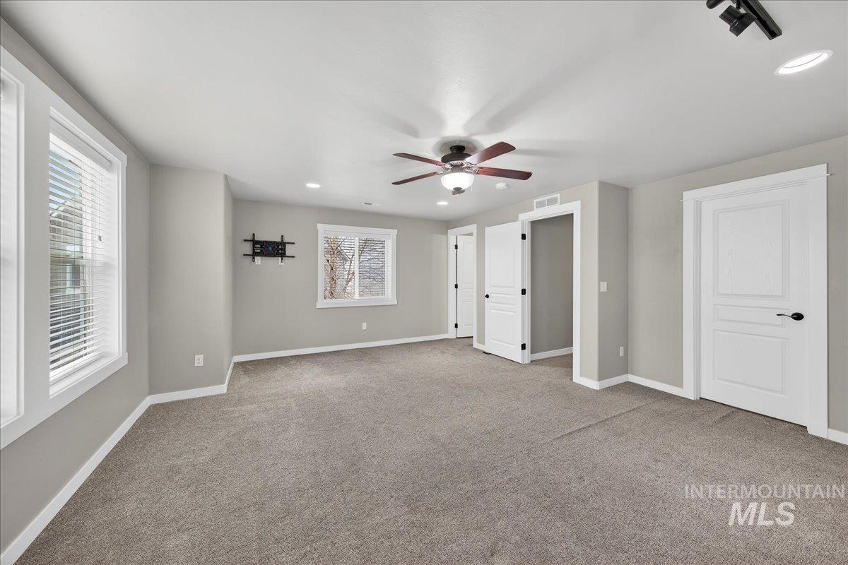 12200 West Oneida Street Boise, ID 83709 - Photo 13 of 35 Unfurnished bedroom with recessed lighting, light carpet, and a ceiling fan