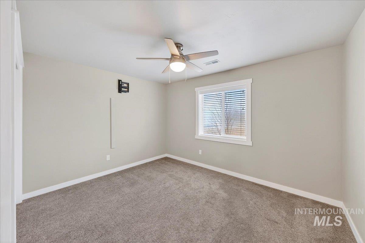12200 West Oneida Street Boise, ID 83709 - Photo 20 of 35 Carpeted empty room featuring baseboards and a ceiling fan