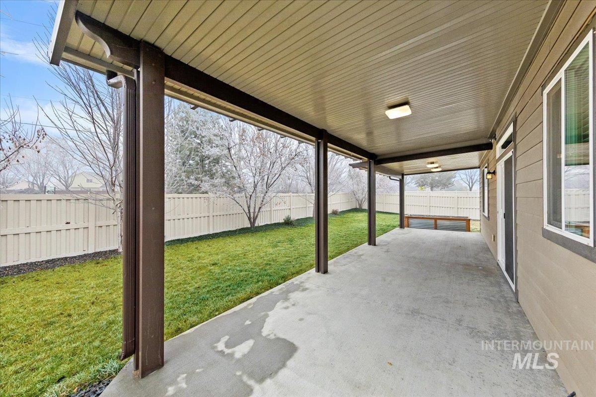 12200 West Oneida Street Boise, ID 83709 - Photo 29 of 35 Fenced backyard with a patio