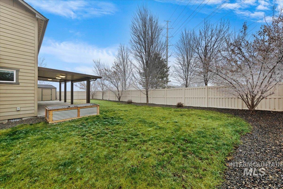 12200 West Oneida Street Boise, ID 83709 - Photo 33 of 35 Fenced backyard with a patio area
