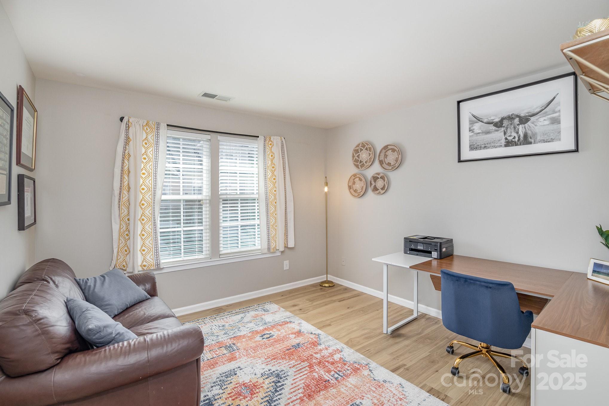 121 Inlet Point Drive Tega Cay, SC 29708 - Photo 12 of 18 a living room with furniture a rug and a window
