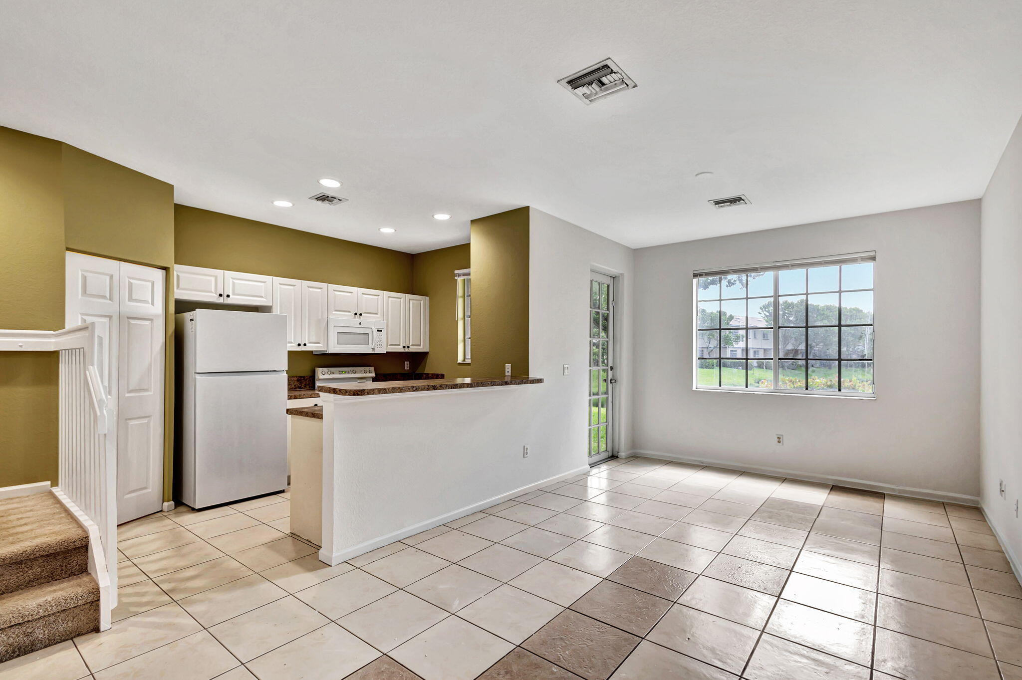 2025 Island Drive Riviera Beach, FL 33404 - Photo 7 of 46 a kitchen with a refrigerator and a stove top oven