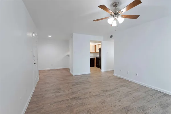 an empty room with fan and a ceiling fan