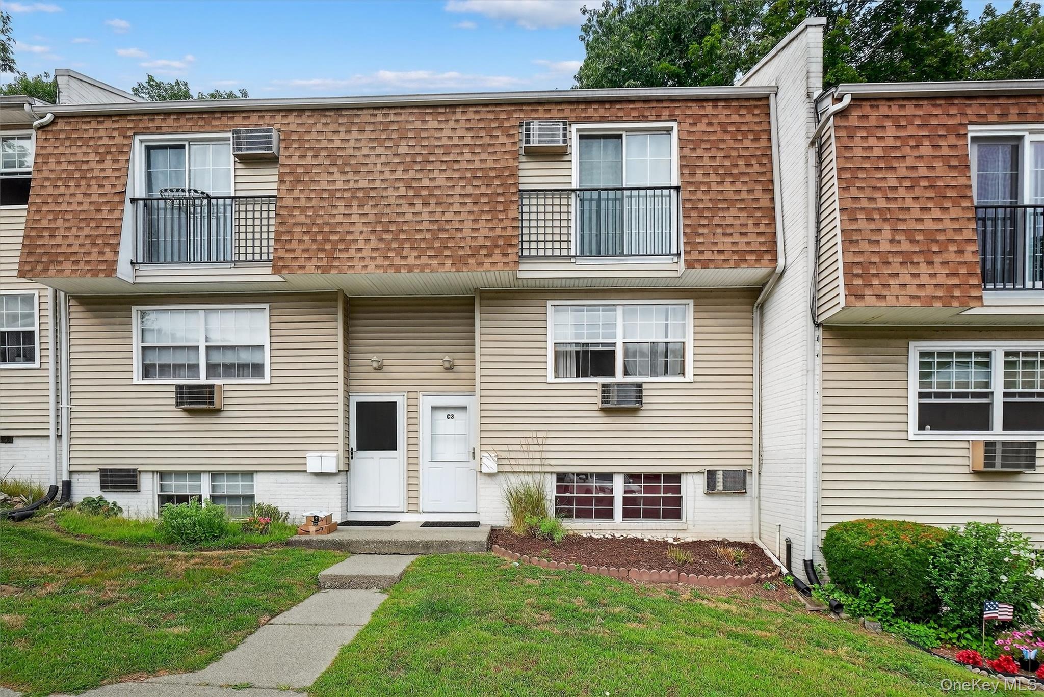 a view of a house with a yard and a large window