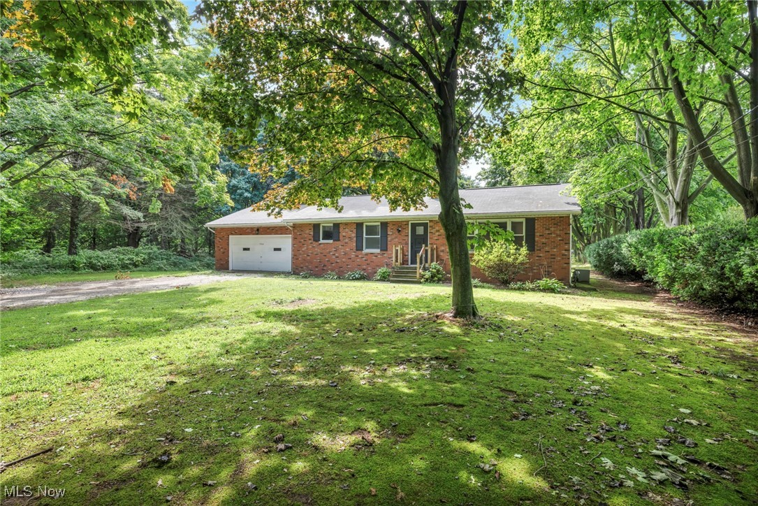 5306 Lockwood Road Madison, OH 44057 - Photo 26 of 28 Ranch-style home featuring a garage and a front lawn