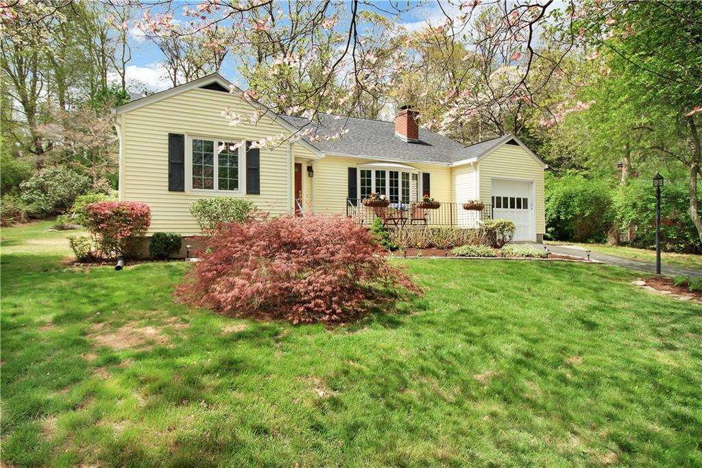 a front view of house with yard and green space