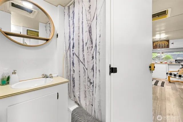 a bathroom with a sink a mirror and a shower