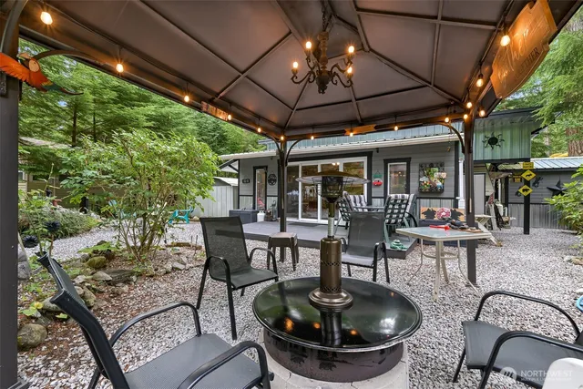 a view of a patio with dining table and chairs