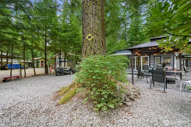 a view of a house with backyard and sitting area