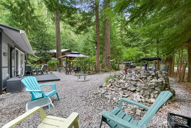 a view of a backyard with chairs and a small yard