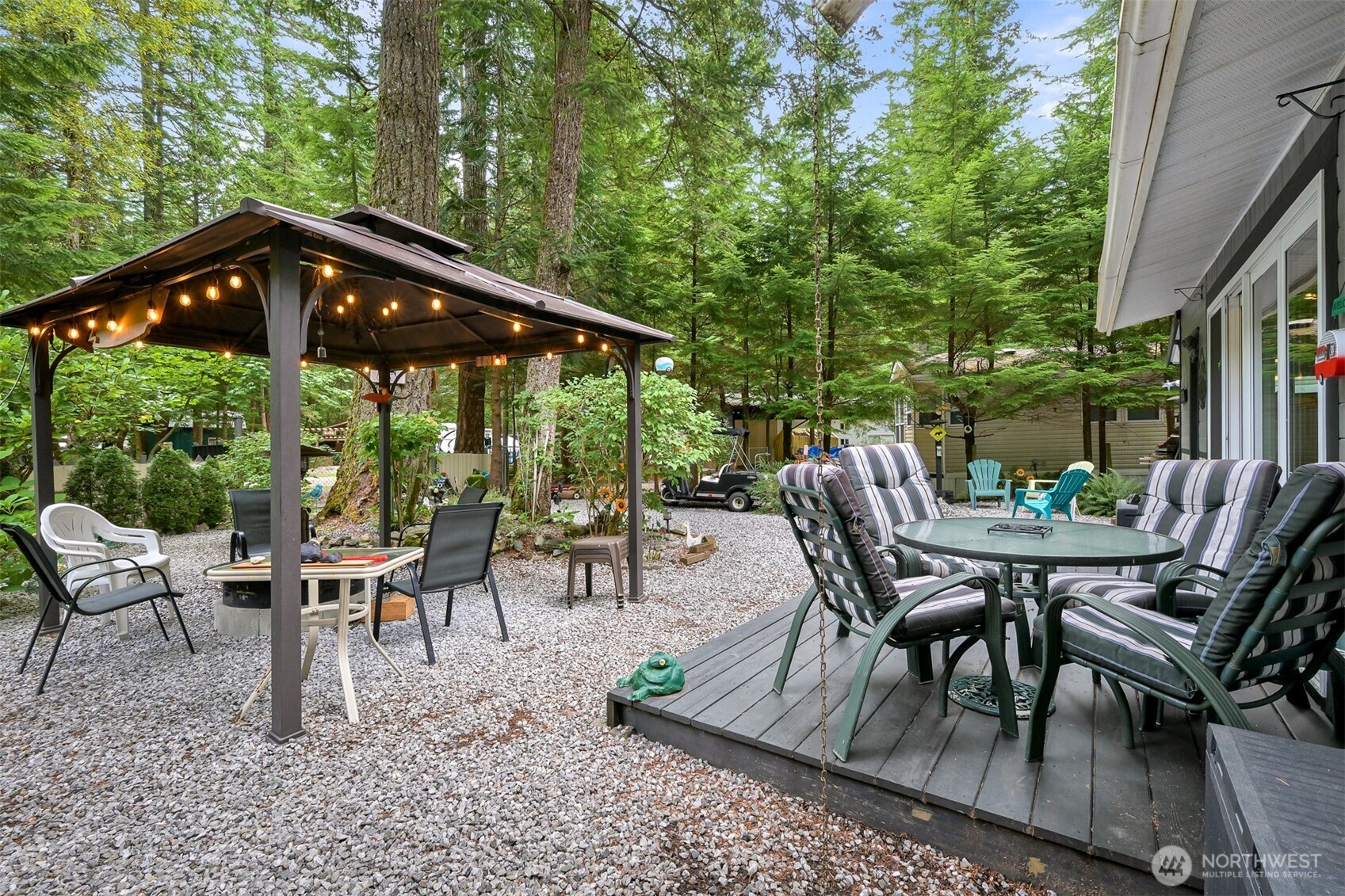 1010 Maple Lane Maple Falls, WA 98266 - Photo 25 of 40 a view of a patio with a table chairs and a backyard