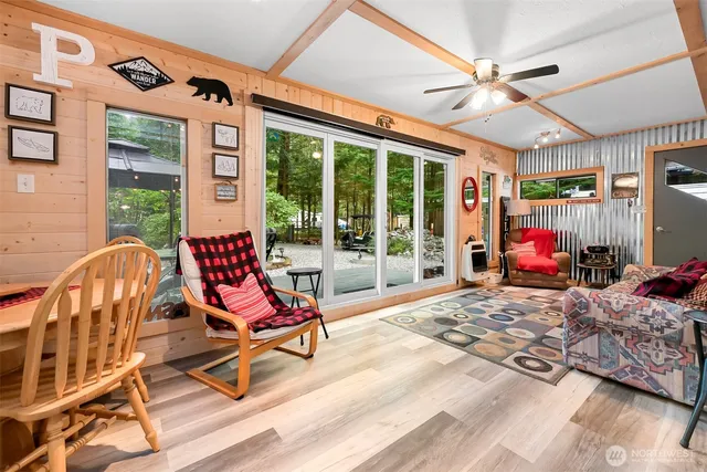 a bedroom with furniture and large windows