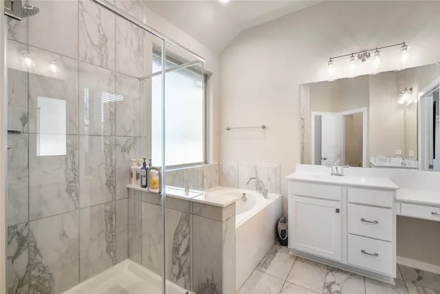 a bathroom with a double vanity sink mirror and shower