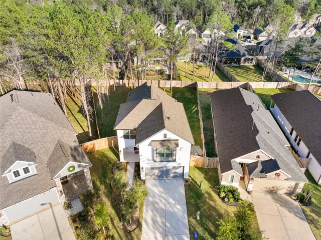 an aerial view of residential houses with outdoor space