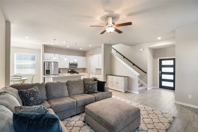 a living room with furniture and kitchen view