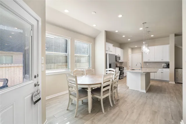 a view of a dining room with furniture and wooden floor
