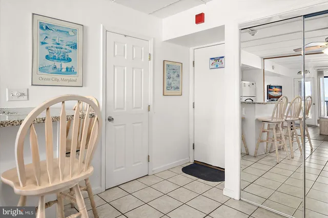 a kitchen with a sink a stove top oven and white cabinets