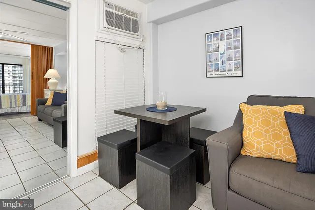 a living room with a couch and a dining table