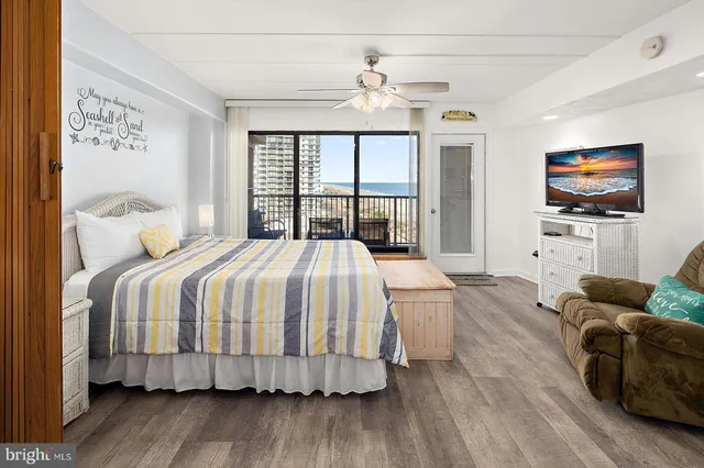 a bedroom with a balcony a bed and a chandelier