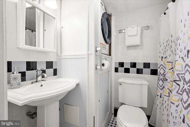 a bathroom with a sink and a washer dryer