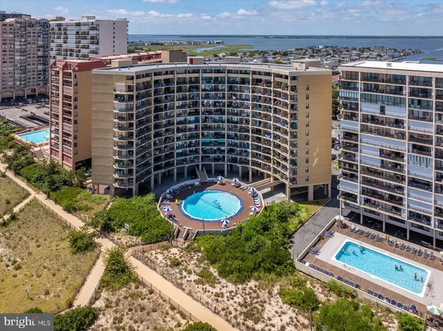 a view of a building with a yard and potted plants
