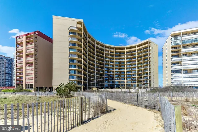 a view of kitchen with windows and refrigerator