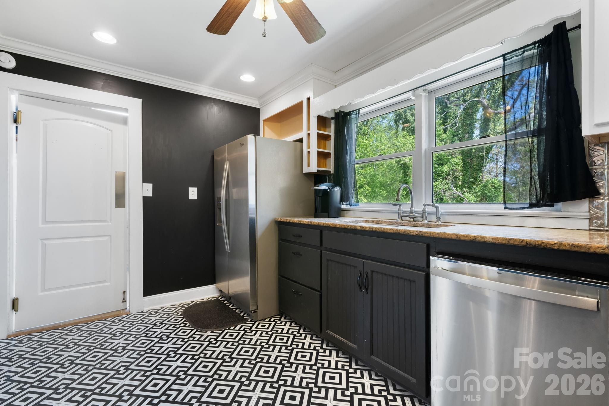 715 Main Street Hudson, NC 28638 - Photo 11 of 26 a kitchen with a large window appliances and cabinets