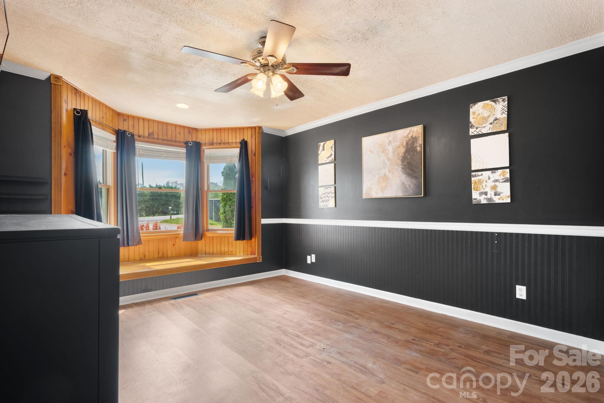 715 Main Street Hudson, NC 28638 - Photo 14 of 26 a view of an empty room with a window and a ceiling fan