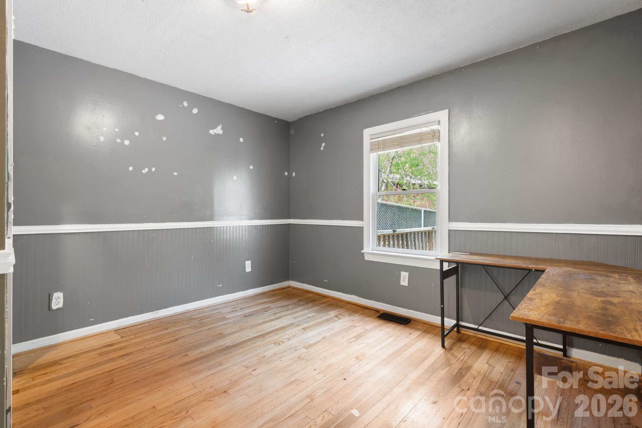 715 Main Street Hudson, NC 28638 - Photo 15 of 26 a view of an empty room with wooden floor and a window