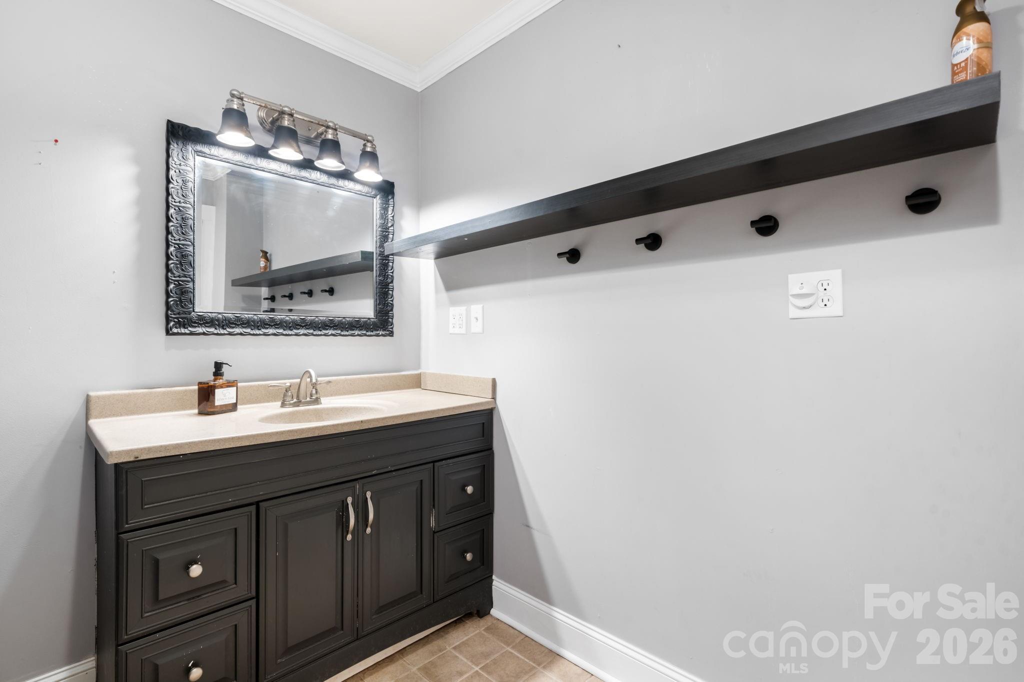 715 Main Street Hudson, NC 28638 - Photo 17 of 26 a bathroom with a sink vanity and mirror