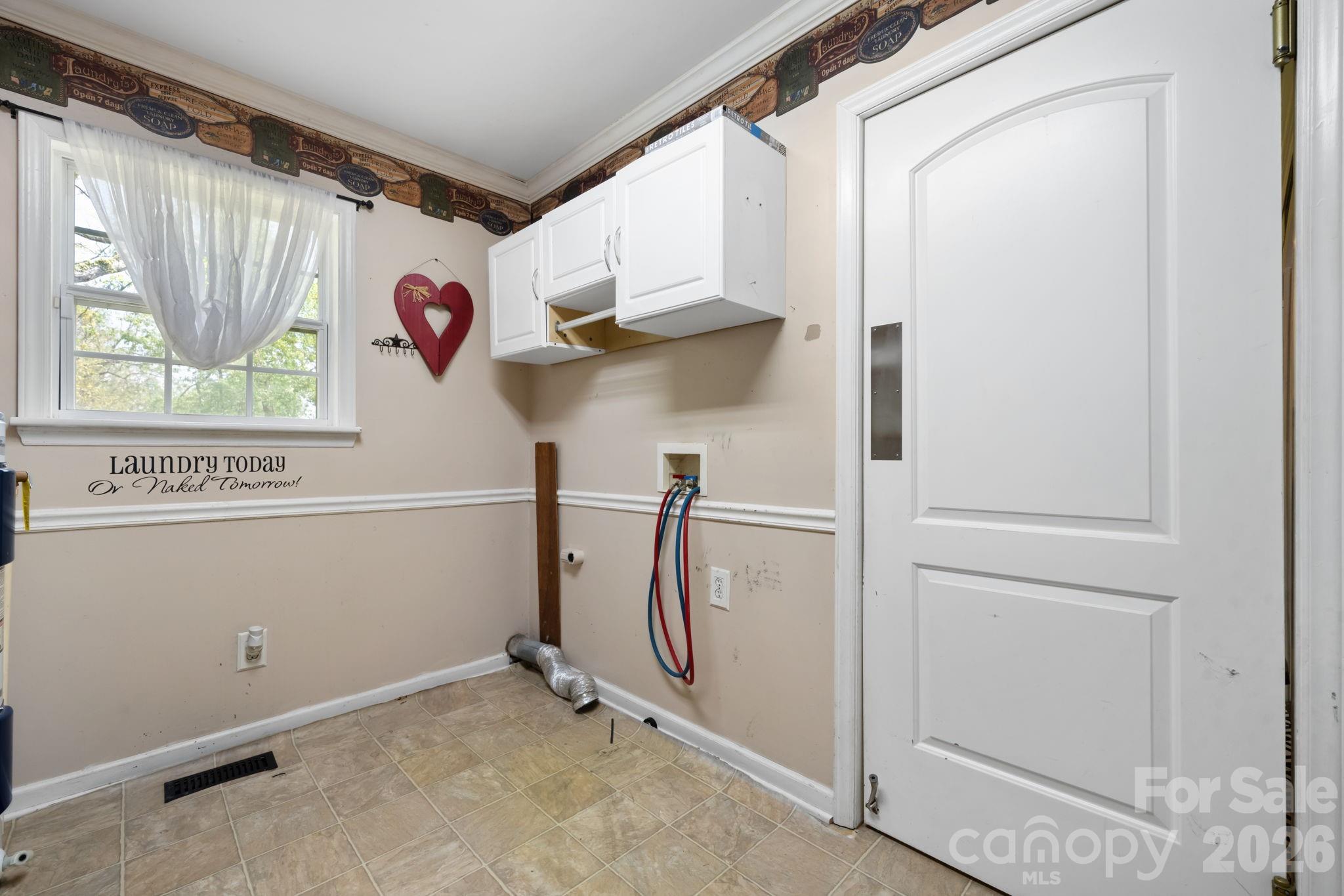 715 Main Street Hudson, NC 28638 - Photo 19 of 26 a view of a hallway with a refrigerator and a window