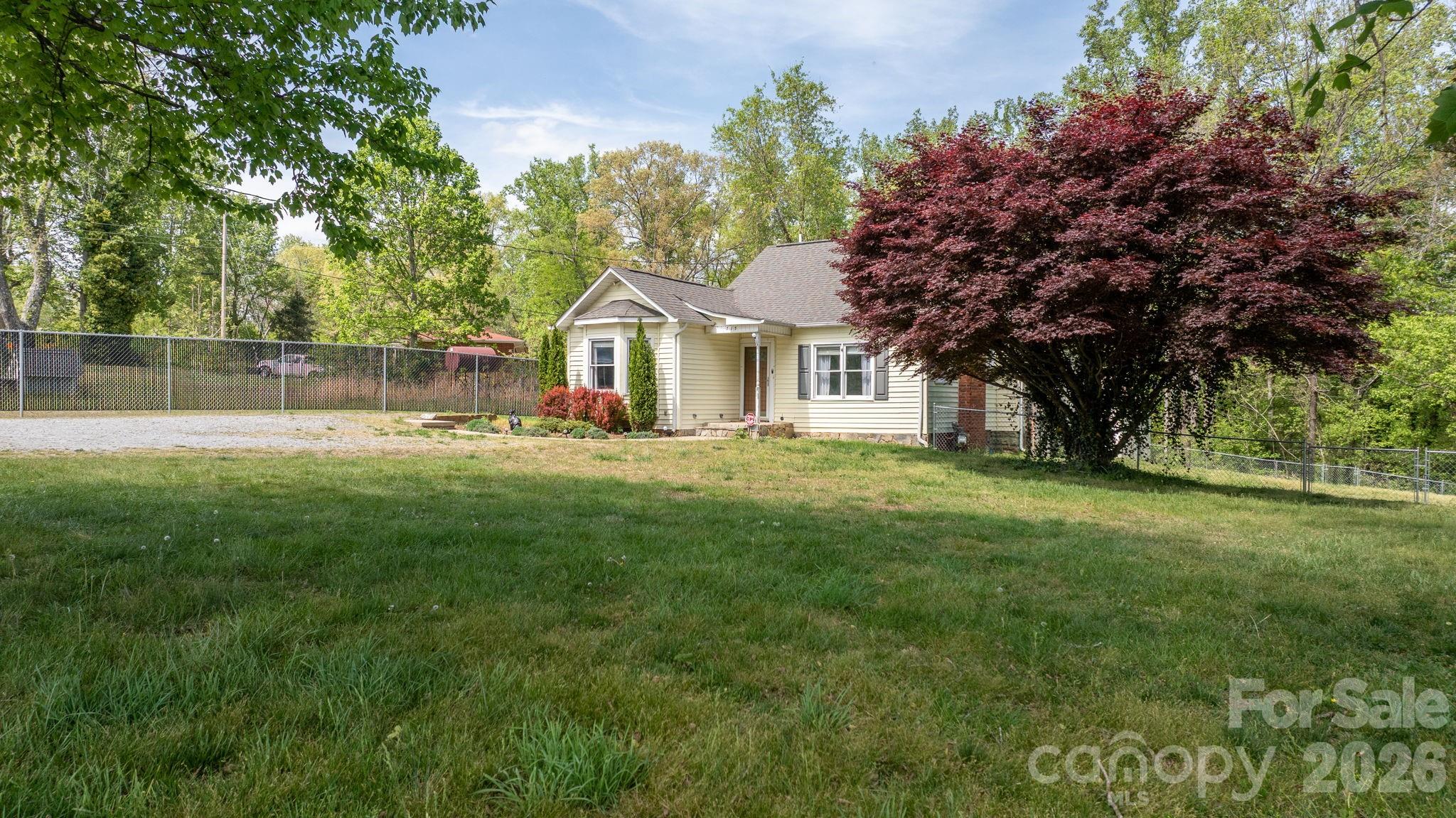 715 Main Street Hudson, NC 28638 - Photo 2 of 26 a front view of a house with garden