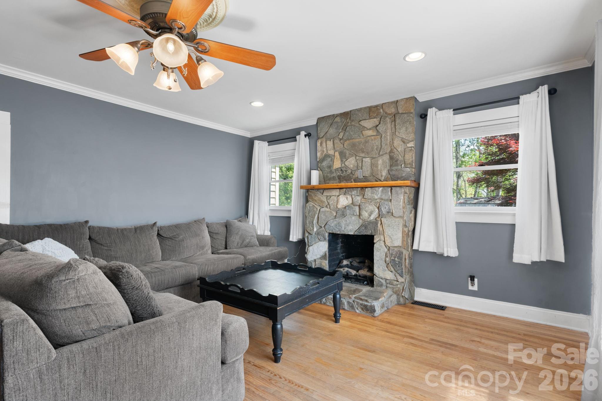 715 Main Street Hudson, NC 28638 - Photo 4 of 26 a living room with furniture a fireplace and a window