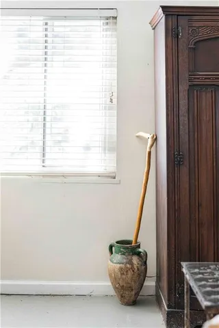 a view of a hallway with a flower pot and a bookshelf
