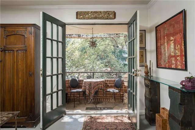a living room with furniture a clock and wall paintings