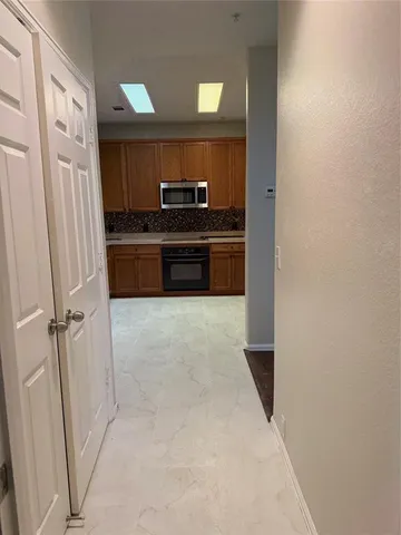 a kitchen with stainless steel appliances a refrigerator and cabinets