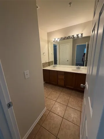 a bathroom with a sink a mirror and vanity
