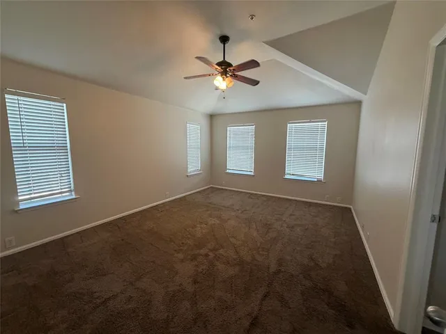 a view of a livingroom with a ceiling fan and window