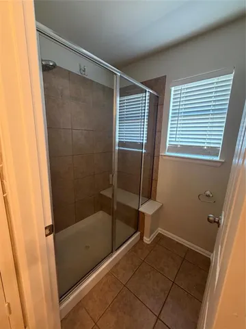 a bathroom with a glass shower door