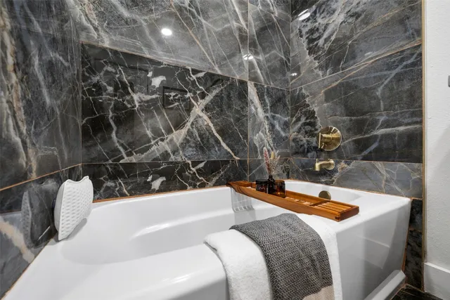 a bathroom with a bathtub and a shower